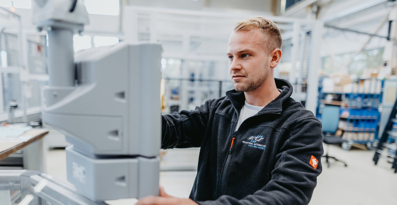 ATS Industrial Automation Employee working on a machine on the shop floor.