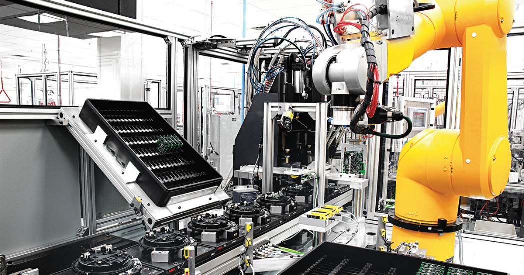 Yellow automation equipment being used in computer & electronic manufacturing.