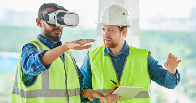 Two men using a training software, one is wearing VR glasses while the other guides the exercise