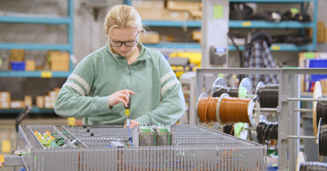 Women working on manufacturing equipment