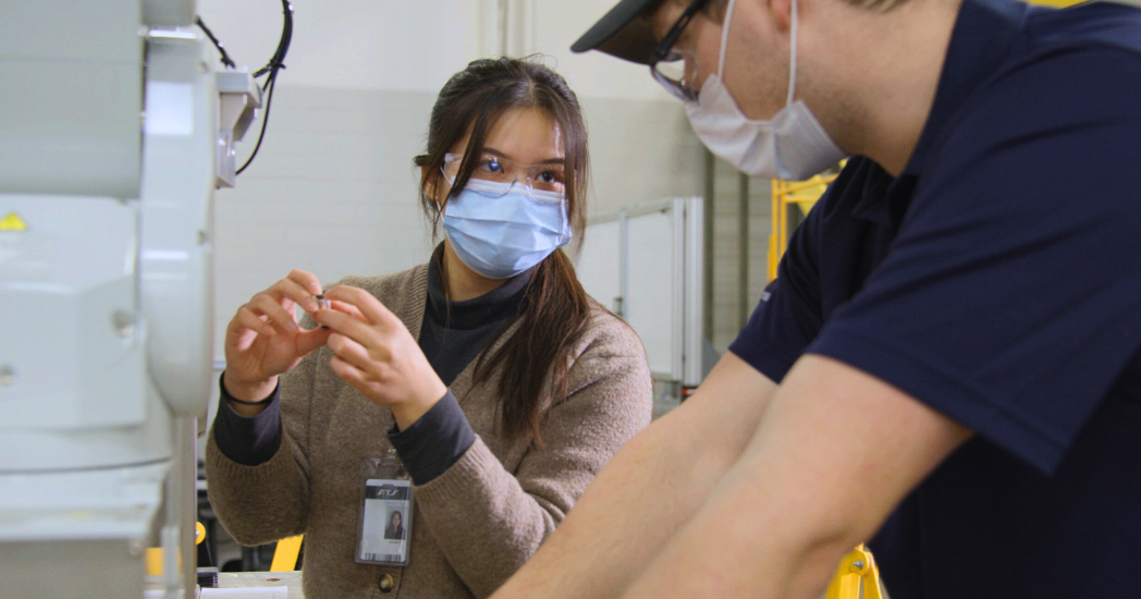 Women working on manufacturing equipment