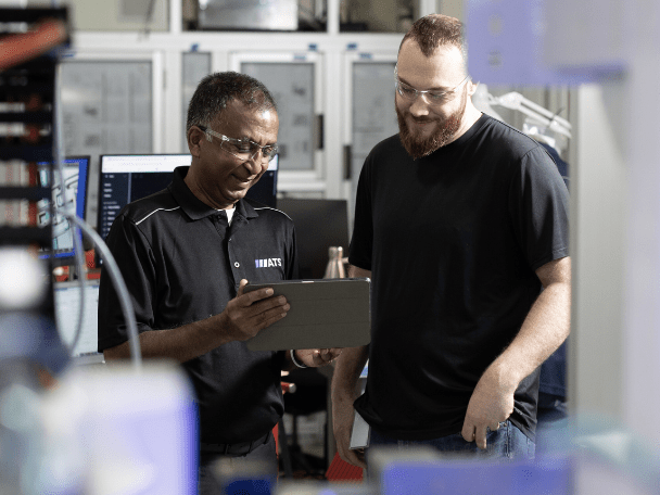 Two ATS employees working on equipment
