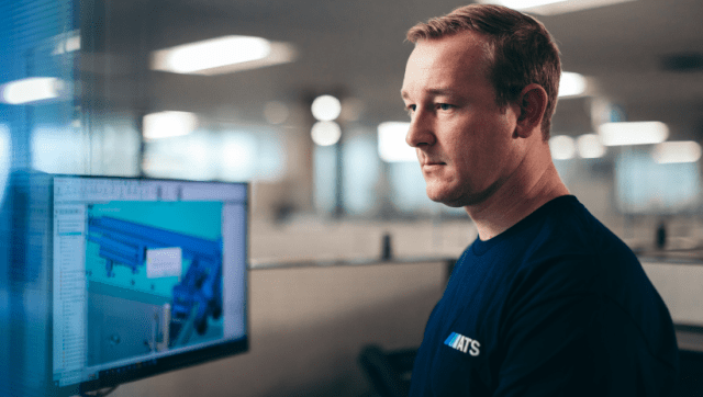 ATS employee working on a digital manufacturing line