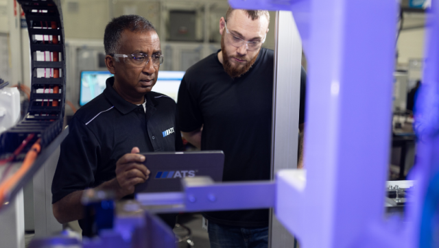 ATS team members working on automation equipment