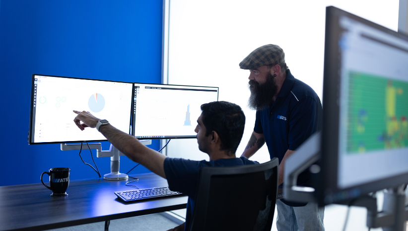 Team looking at data on computer