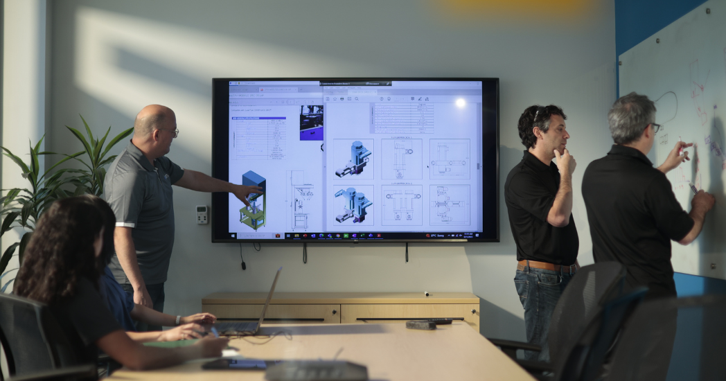 ATS team working on automation equipment designs