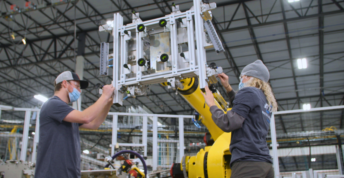 ATS team members working on manufacturing equipment